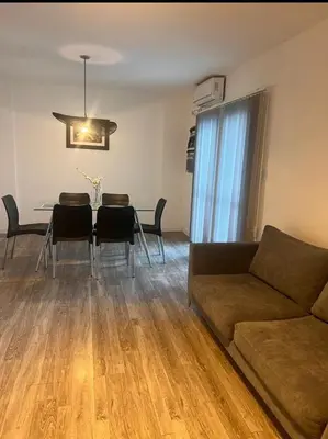 a living room with a couch and a table with chairs at Vive Carlos Paz in Villa Carlos Paz