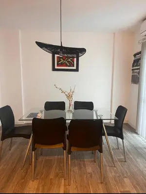 a dining room with a glass table and chairs at Vive Carlos Paz in Villa Carlos Paz