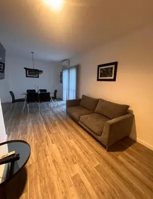a living room with a couch and a dining room at Vive Carlos Paz in Villa Carlos Paz