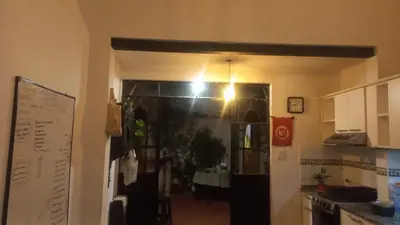 a kitchen with a door leading to a dining room at Casa Corna in Río Cuarto