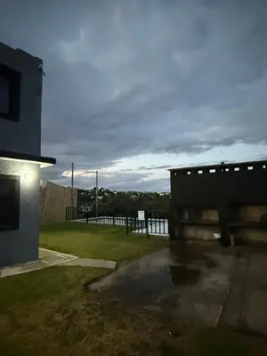 a house with a puddle of water in a yard at Cabaña El Bosquecito in Estancia Vieja
