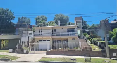 a house with a fence in front of it at Departamento Villa Carlos Paz Excelente Ubicación in Villa Carlos Paz