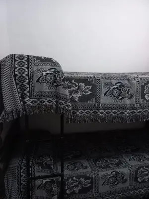 a couch with a blanket on top of a floor at Departamento Villa Carlos Paz Excelente Ubicación in Villa Carlos Paz