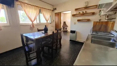 a kitchen with a table with a cat sitting on it at Departamento Villa Carlos Paz Excelente Ubicación in Villa Carlos Paz