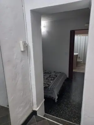 a small room with a bed in a room with a mirror at Departamento Villa Carlos Paz Excelente Ubicación in Villa Carlos Paz