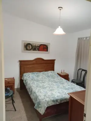 a bedroom with a bed and a table and a chair at La Serranita de Miguel in Villa Serranita