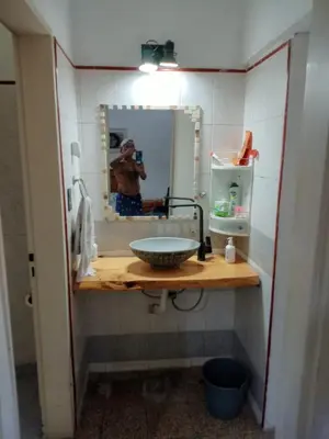 a man taking a picture of a sink in a bathroom at La Serranita de Miguel in Villa Serranita