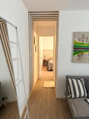 a hallway leading to a bedroom with a stair case at Nuevocentro Apartment in Cordoba
