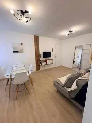 a living room with a bed and a dining table at Nuevocentro Apartment in Cordoba