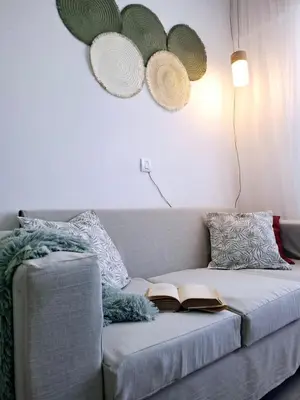 a living room with a couch with a book on it at Monoambiente luminoso con Jacuzzi Relax y estilo in Cordoba