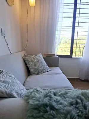 a living room with a couch and a window at Monoambiente luminoso con Jacuzzi Relax y estilo in Cordoba