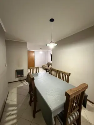 a dining room with a table and chairs and a couch at Departamento alquiler temporal Nueva Cordoba in Cordoba
