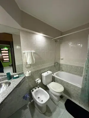a bathroom with a toilet and a bath tub at Departamento alquiler temporal Nueva Cordoba in Cordoba