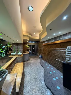 a lobby with a brick wall and a clock on the ceiling at Departamento alquiler temporal Nueva Cordoba in Cordoba
