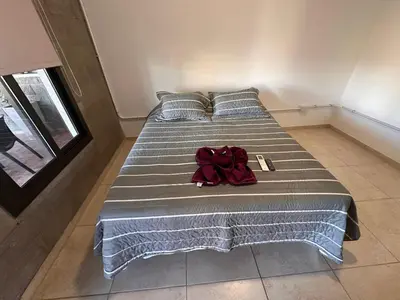a large bed with a red backpack sitting on it at Sierras y Volcanes in Taninga