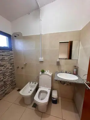 a bathroom with a toilet and a sink at Sierras y Volcanes in Taninga