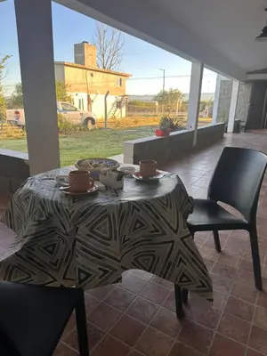 a table and chairs in a patio with a table and chairs at Sierras y Volcanes in Taninga