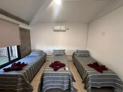 a room with four beds with red bows on them at Sierras y Volcanes in Taninga