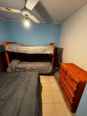 a bedroom with two bunk beds and a dresser at Casa pleno centro Villa Dolores in Villa Dolores