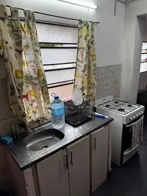 a kitchen with a sink and a stove at Casa pleno centro Villa Dolores in Villa Dolores