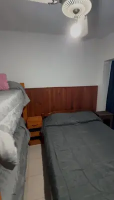 a bedroom with two beds and a ceiling fan at Casa pleno centro Villa Dolores in Villa Dolores