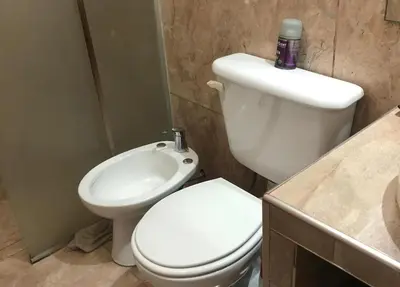 a bathroom with a white toilet and a sink at Casa- alojamiento Gerez in San Antonio de Arredondo