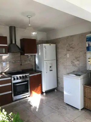 a kitchen with a white refrigerator and a stove at Casa- alojamiento Gerez in San Antonio de Arredondo