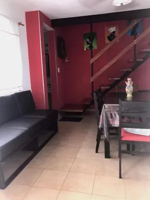 a living room with a black couch and a table at Complejo Soles de Oro in Villa Icho Cruz
