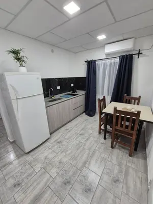a kitchen with a table and chairs and a refrigerator at Colibri 3 in Merlo