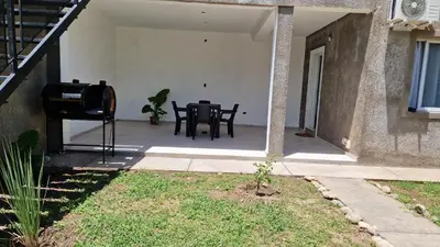 a patio of a house with a table and chairs at Colibri 3 in Merlo