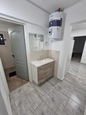 a bathroom with a sink and a mirror at Colibri 3 in Merlo
