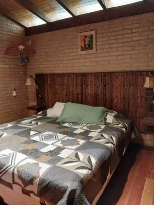 a bedroom with a large bed in a brick wall at soy ahora in San Javier