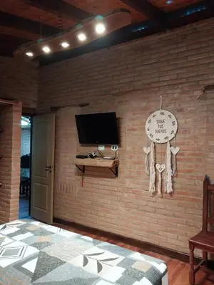 a room with a brick wall with a clock on it at soy ahora in San Javier