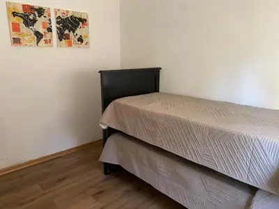 a bed in a room with a picture on the wall at San Plácido in Bialet Massé