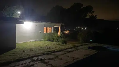 a house with a light on the side of it at night at San Plácido in Bialet Massé