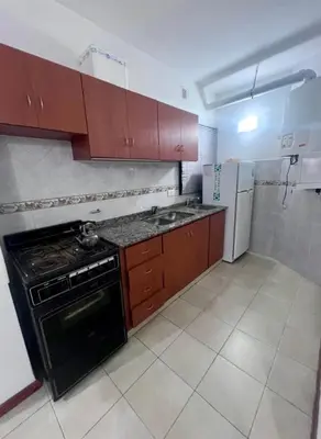 a kitchen with a stove and a refrigerator at Edificio Panorámico in Villa Carlos Paz