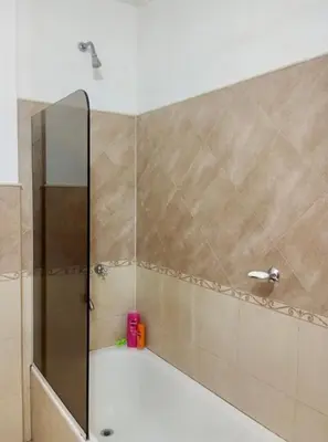 a shower with a glass door in a bathroom at Edificio Panorámico in Villa Carlos Paz