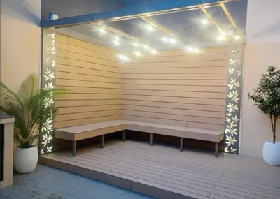 a wooden bench sitting on a deck with lights at Edificio Panorámico in Villa Carlos Paz