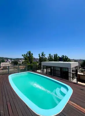 a swimming pool on the deck of a house at Edificio Panorámico in Villa Carlos Paz