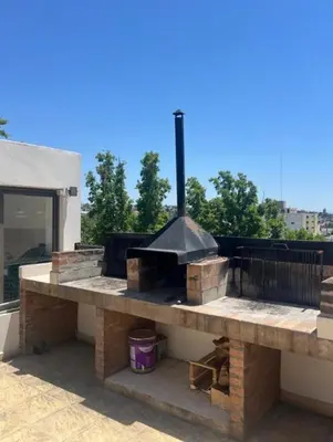 a large outdoor grill on top of a building at Edificio Panorámico in Villa Carlos Paz