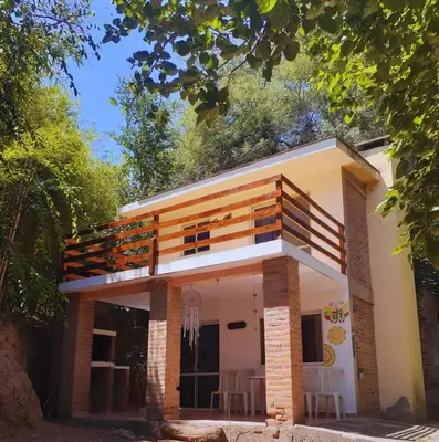 a small house with chairs in front of it at Dúplex el descanso in Villa Anizacate