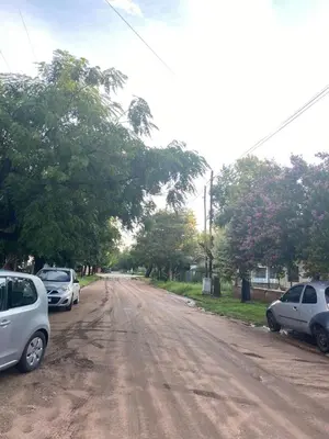 a dirt road with cars parked on the side at Depto Dos Plantas en Bialet Massé in Bialet Massé