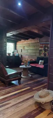 a living room with a couch and a table at Cabaña tierra de sueños in Santa Rosa de Calamuchita