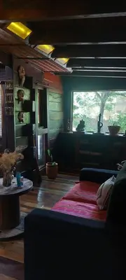 a living room with a couch and a table at Cabaña tierra de sueños in Santa Rosa de Calamuchita