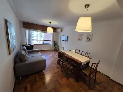 a living room with a couch and a table at Cómodo departamento en Nueva Córdoba in Cordoba