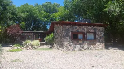 a small stone building with a window in front at Tierra de Sueños in Santa Rosa de Calamuchita