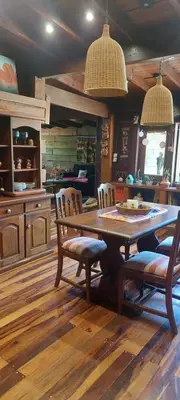 a kitchen with a wooden table and chairs in a room at Tierra de Sueños in Santa Rosa de Calamuchita