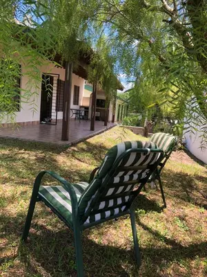 a green bench sitting in front of a house at La Casa de Juan in San Antonio de Arredondo