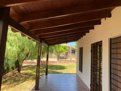 an outdoor patio with a wooden pergola at La Casa de Juan in San Antonio de Arredondo
