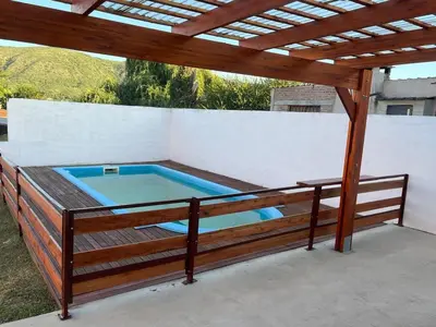 a hot tub on a patio with a wooden pergola at La soñada San Antonio de Arredondo in San Antonio de Arredondo